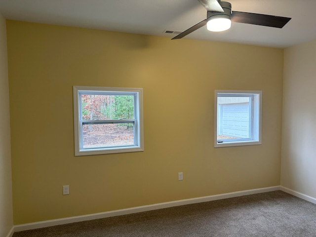 carpeted spare room featuring ceiling fan