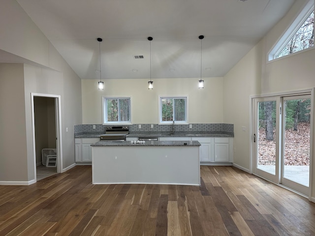 kitchen with white cabinets, a healthy amount of sunlight, pendant lighting, and dark hardwood / wood-style flooring