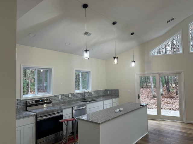 kitchen featuring white cabinets, a healthy amount of sunlight, decorative backsplash, and appliances with stainless steel finishes