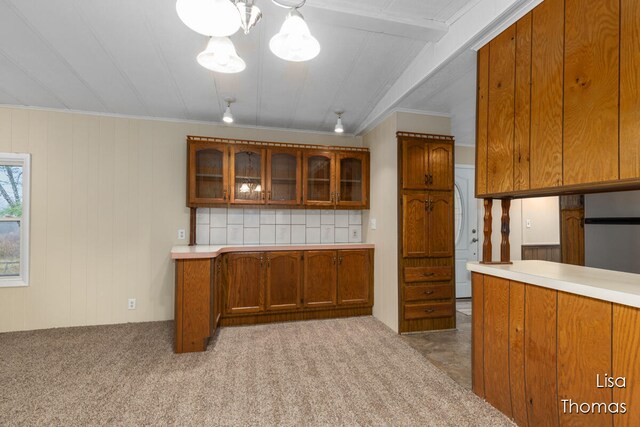 kitchen with crown molding, light carpet, tasteful backsplash, and stainless steel fridge