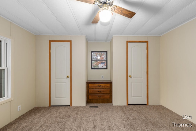 unfurnished bedroom with ceiling fan and carpet floors