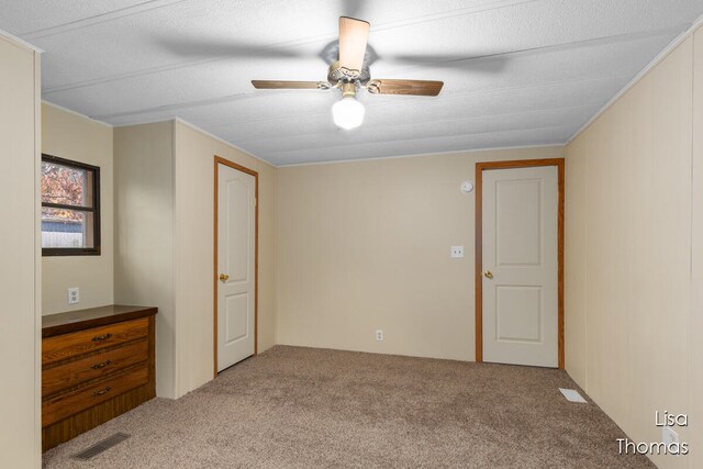 unfurnished bedroom with light carpet and ceiling fan