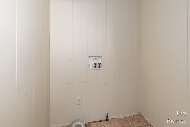 washroom featuring hookup for a washing machine and wooden walls