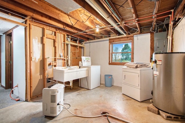 basement featuring electric panel, sink, gas water heater, and separate washer and dryer