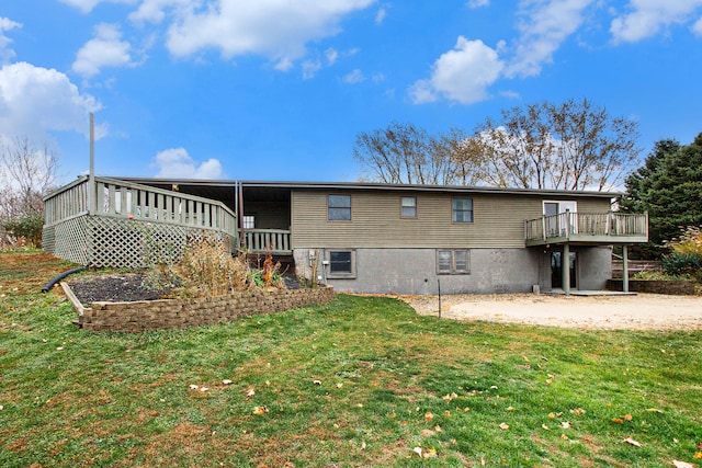 back of property with a wooden deck and a yard