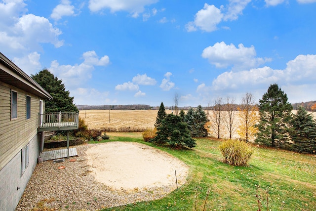 view of yard with a deck and a rural view