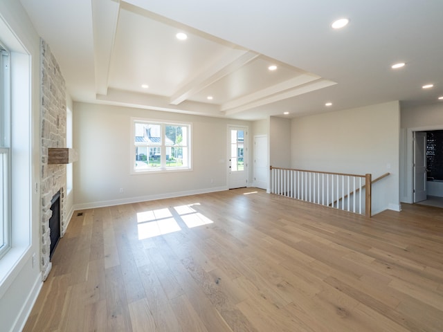 unfurnished living room featuring light wood-type flooring and a fireplace