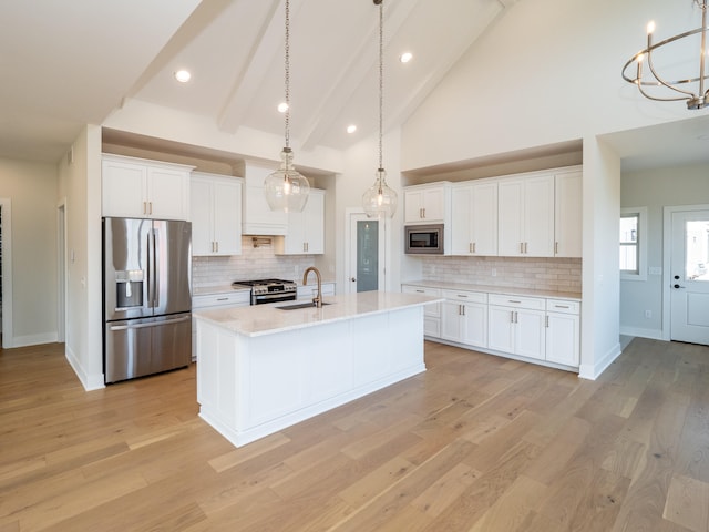 kitchen featuring white cabinetry, light wood-type flooring, and appliances with stainless steel finishes