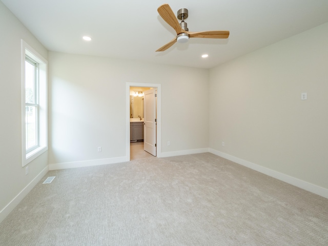 carpeted empty room with ceiling fan