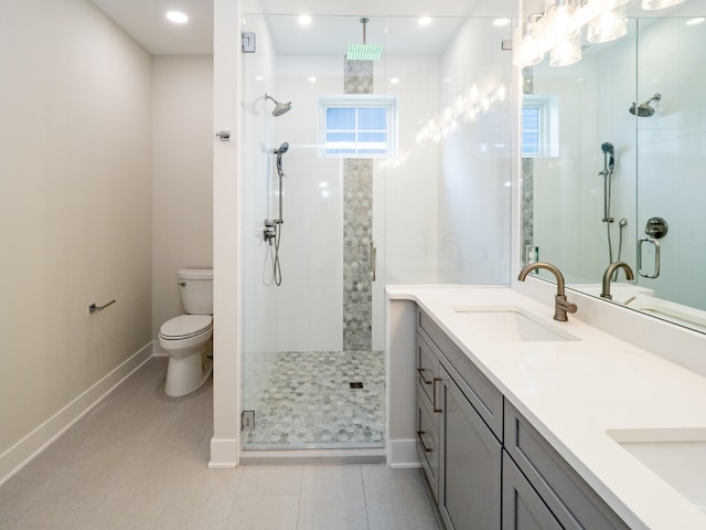 bathroom featuring toilet, an enclosed shower, vanity, and plenty of natural light