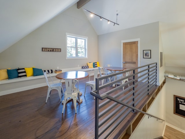 dining area with lofted ceiling with beams and dark hardwood / wood-style floors