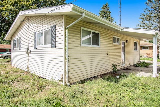 view of side of property with a yard