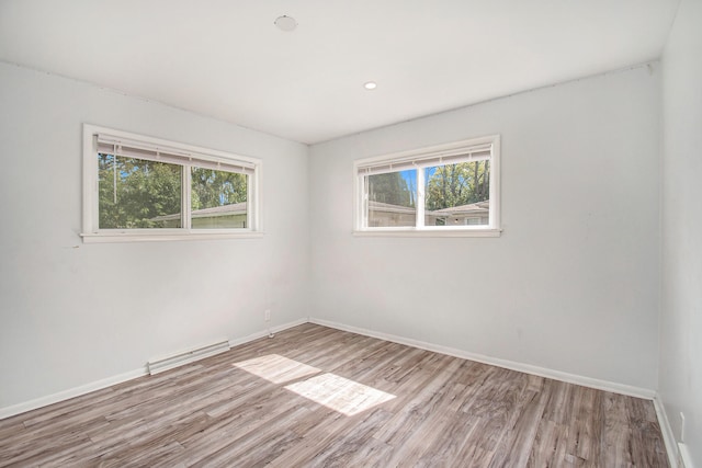 spare room with light hardwood / wood-style flooring