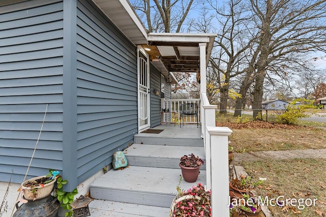 view of exterior entry with a porch