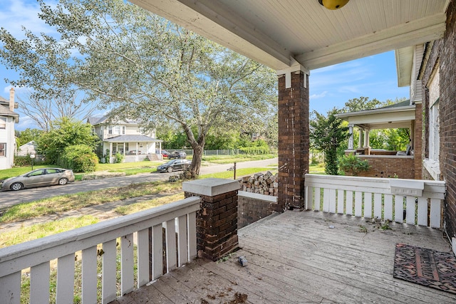 wooden terrace featuring covered porch