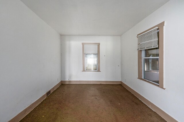 empty room featuring dark colored carpet