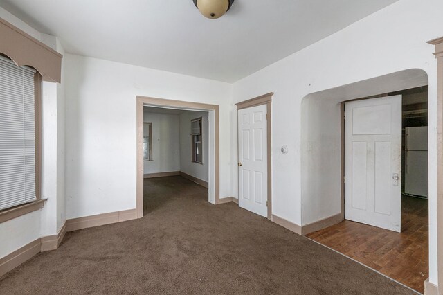 empty room featuring dark colored carpet