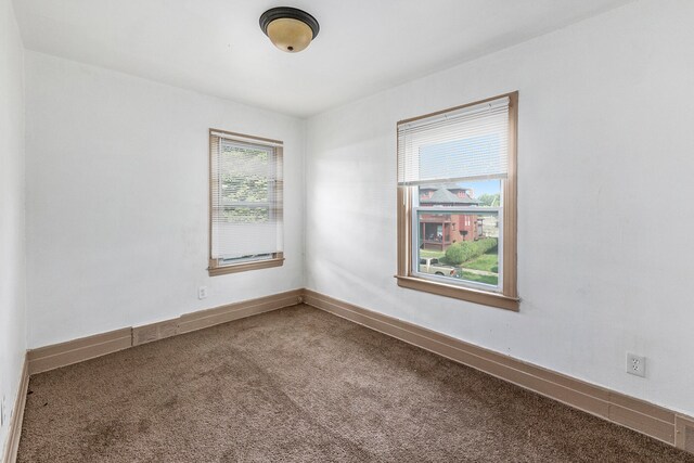 unfurnished room with a healthy amount of sunlight and carpet flooring