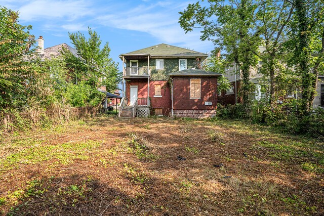 rear view of property with a balcony