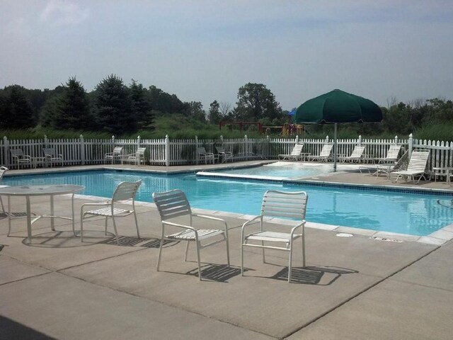 view of swimming pool featuring a patio area