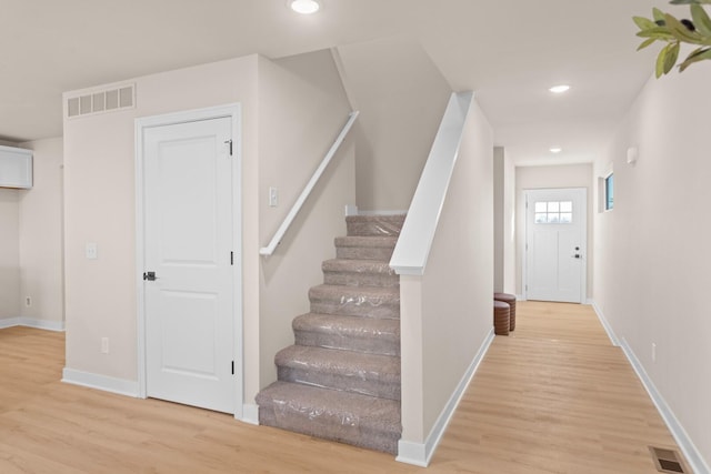 staircase with wood-type flooring