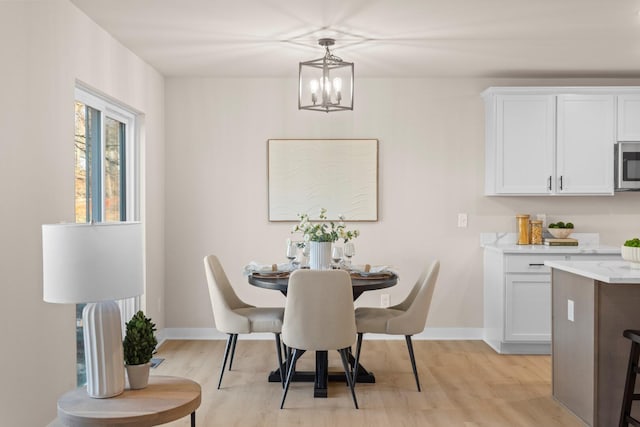 dining area featuring an inviting chandelier and light hardwood / wood-style floors