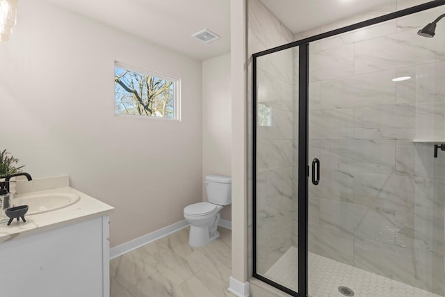 bathroom featuring vanity, toilet, and a shower with door