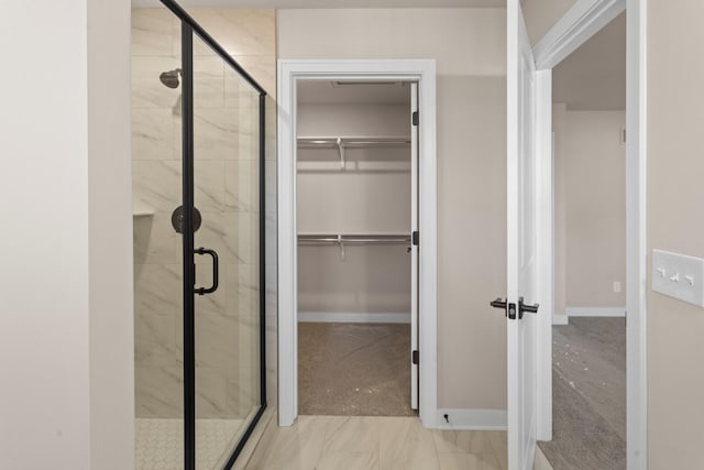 bathroom featuring a shower with shower door