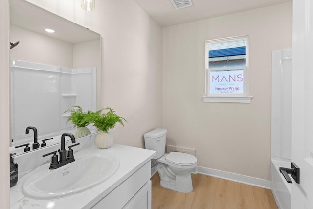 full bathroom with vanity, tub / shower combination, wood-type flooring, and toilet