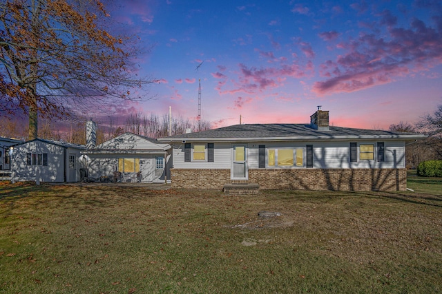 back house at dusk with a yard