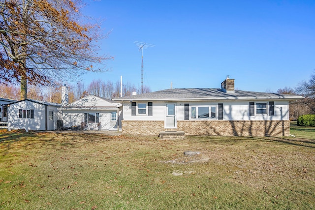 rear view of house with a yard