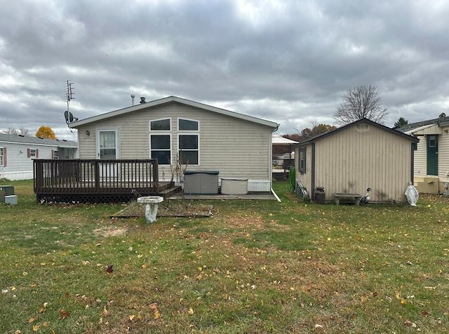 rear view of house with a wooden deck and a yard