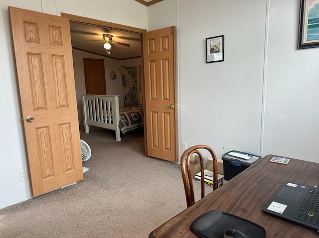 carpeted office featuring ceiling fan and ornamental molding