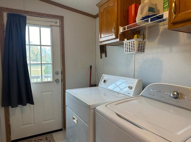 laundry room featuring cabinets, washing machine and dryer, and ornamental molding