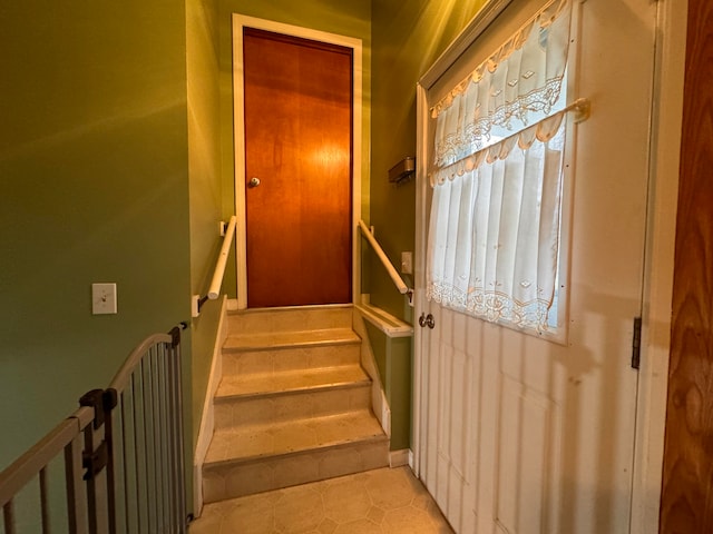 stairway with tile patterned flooring