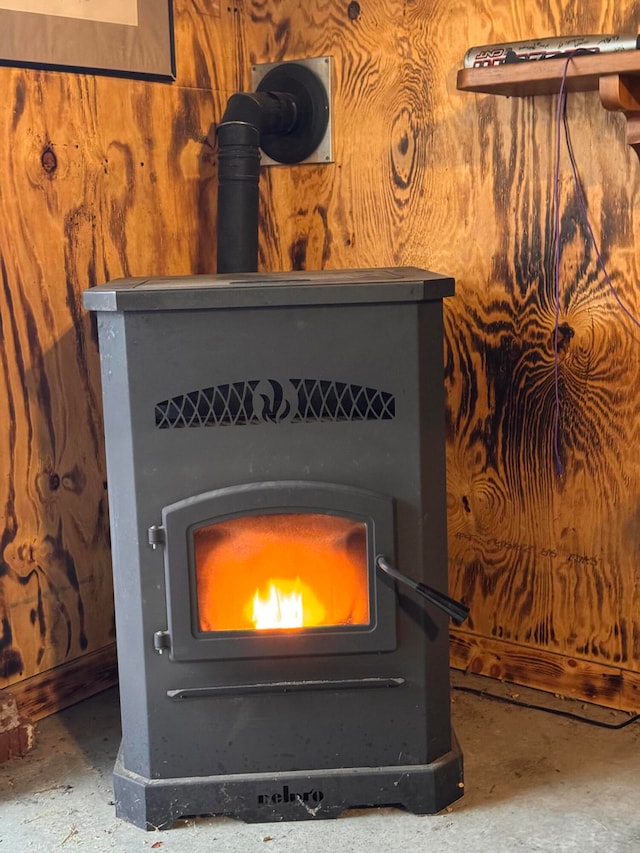 interior details featuring a wood stove and concrete floors