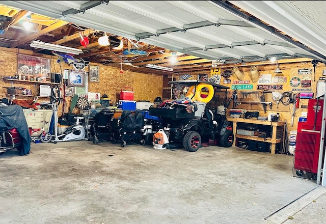 garage featuring a garage door opener and a workshop area