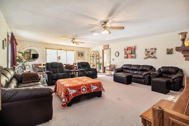 living room featuring a textured ceiling, light carpet, and ceiling fan