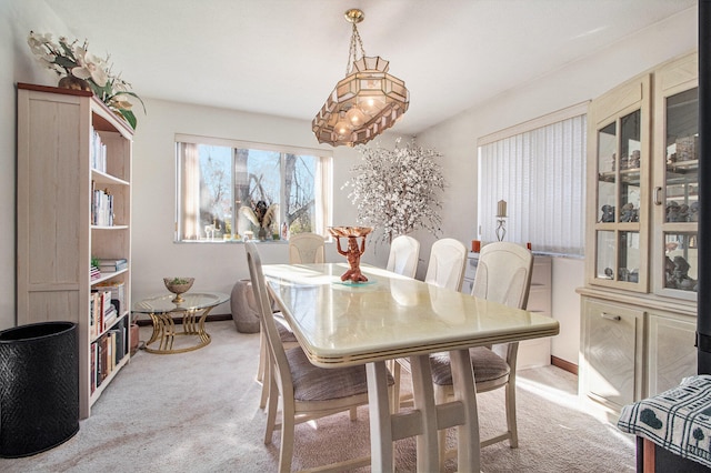 dining area featuring light carpet