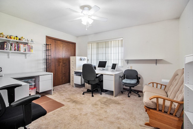 carpeted office featuring ceiling fan