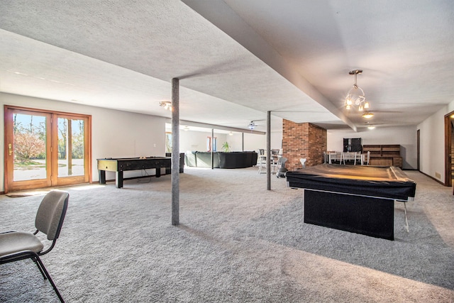 recreation room with a textured ceiling, carpet flooring, and billiards