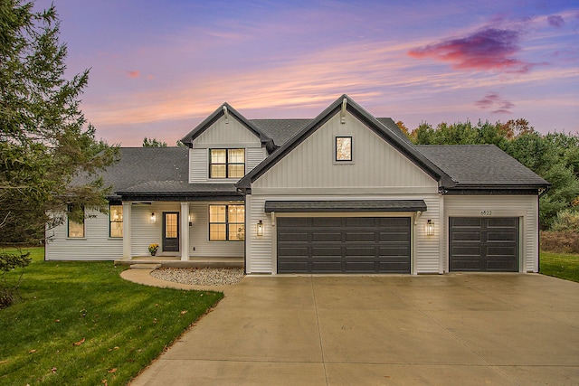 view of front of home featuring a garage and a lawn