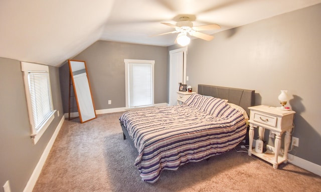 carpeted bedroom with ceiling fan and vaulted ceiling