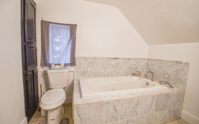 bathroom with tile patterned flooring, tiled bath, toilet, and lofted ceiling