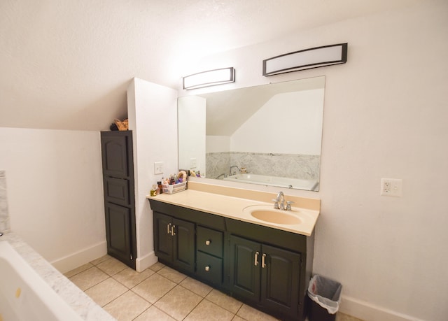 bathroom with tile patterned flooring, vanity, lofted ceiling, and a tub