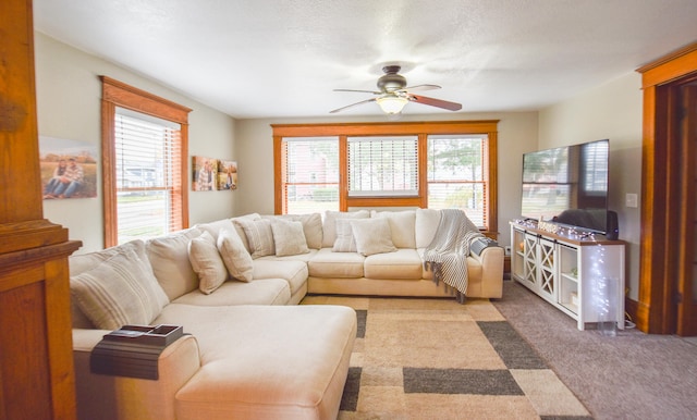 carpeted living room featuring ceiling fan and a healthy amount of sunlight