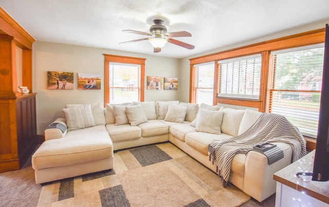 carpeted living room featuring ceiling fan