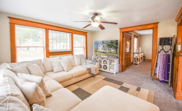 carpeted living room with ceiling fan