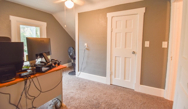 carpeted office space with ceiling fan and lofted ceiling