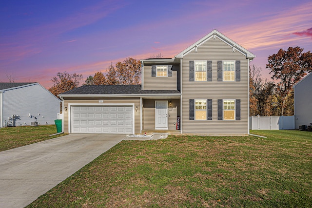 view of front property with a lawn and a garage